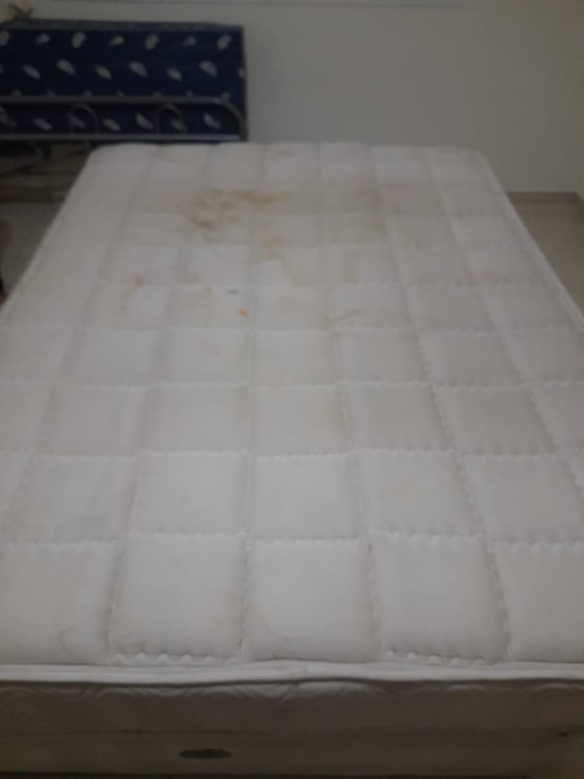 Mattress before deep cleaning showing stains and dust mites accumulation in Dubai home