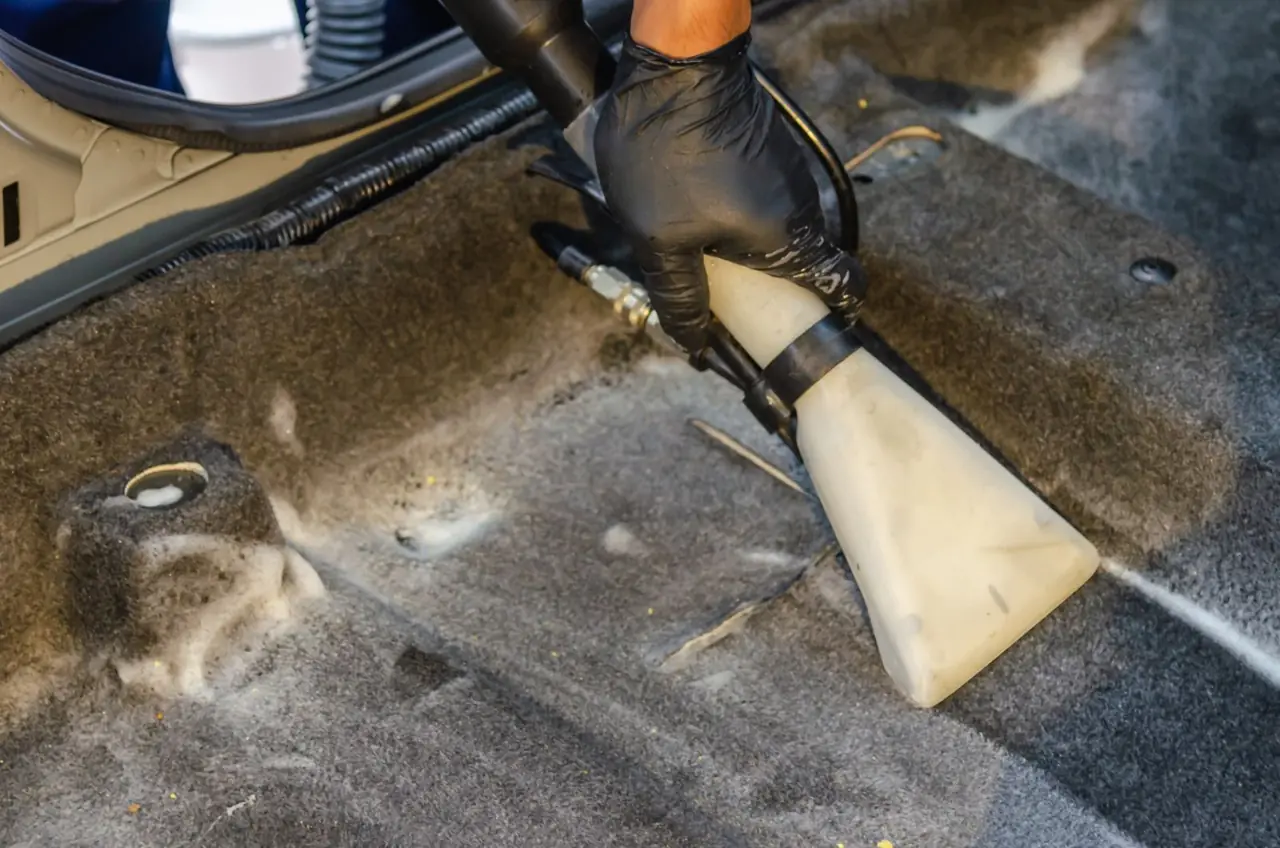 Car carpet cleaned with an extraction nozzle