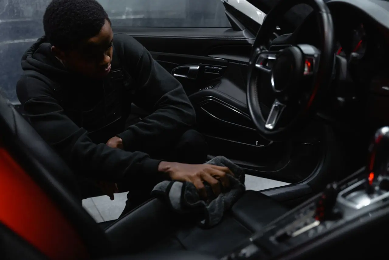 Car seat being wiped during cabin sanitising